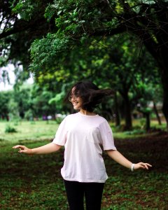 Photography Of A Smiling Woman Near Trees