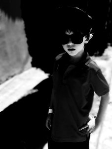 Grayscale Photography Of Boy Wearing Polo Shirt And Sunglasses photo