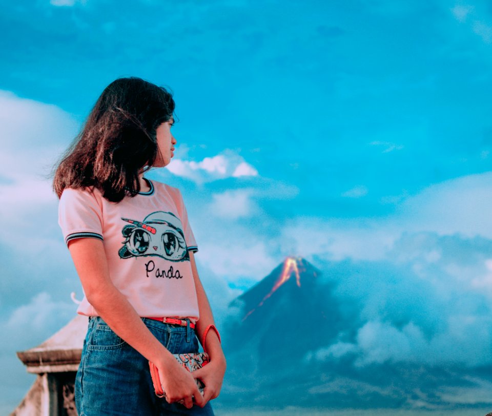 Photography Of A Girl In Front Of Erupting Volcano