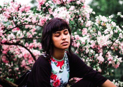 Woman Wearing White And Red Floral Crew-neck Shirt Near Pink Petaled Plant photo