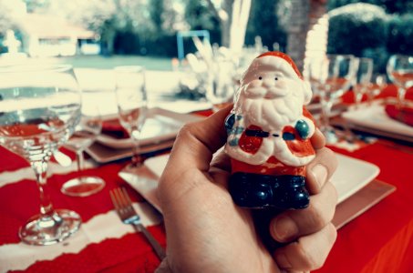 Person Holding Santa Claus Figurine photo