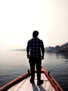 Man Standing On Wooden Boat photo