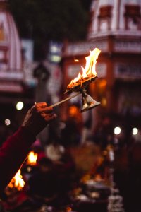 Person Holding Lamp With Flame photo