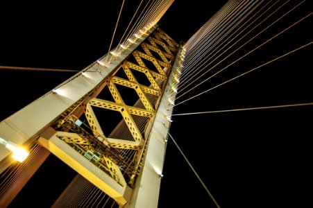 Low Angle Photography Of White And Yellow Suspension Bridge At Nighttime photo