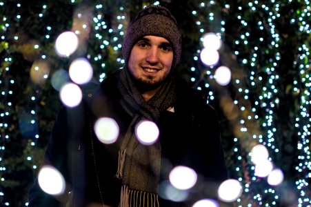Man Wearing Snow Coat With Bokeh Light Background photo