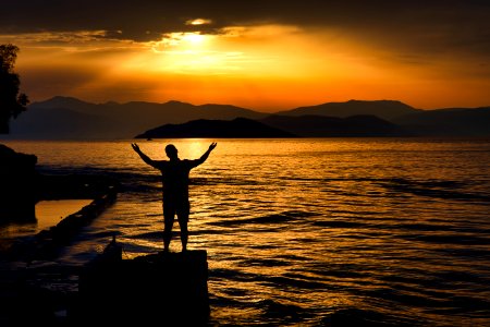 Silhouette Photo Of Person Standing Near Beach photo