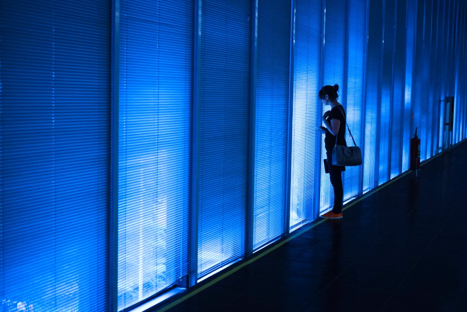 Woman Standing Near Blue Led Wall