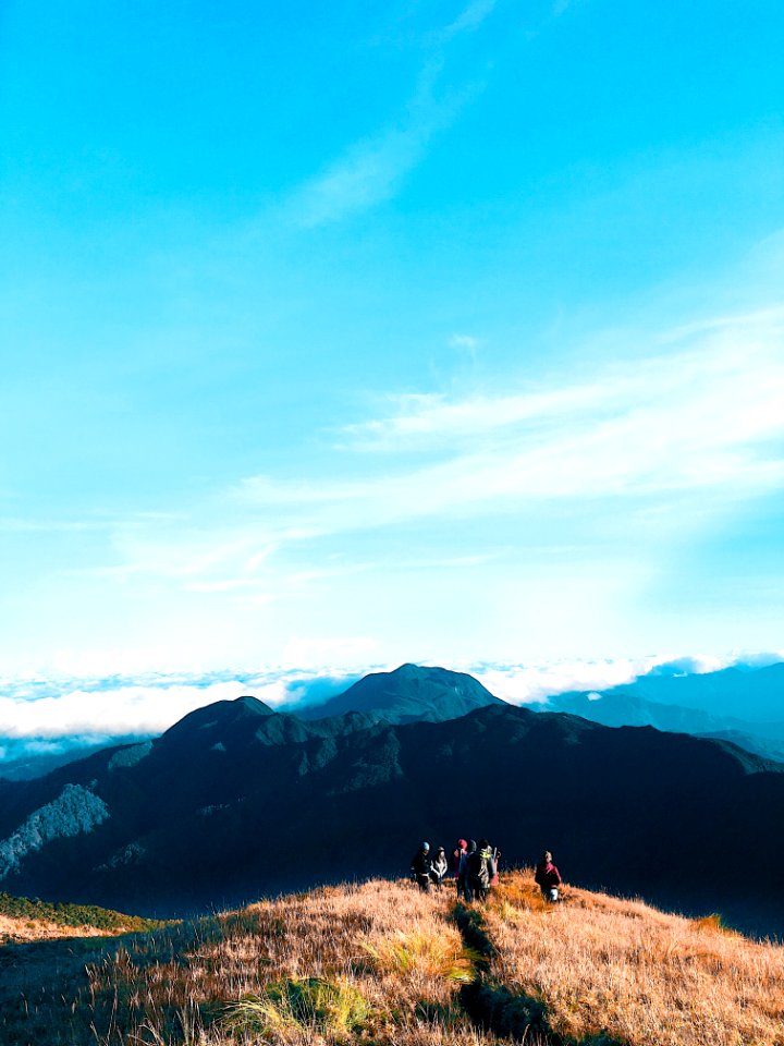 People Walking On Top Of Mountain
