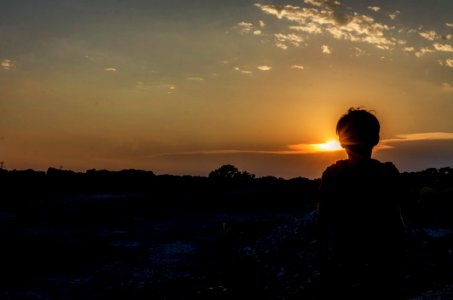 Silhouette Of A Boy During Sunset photo