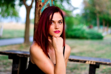 Woman In Black Tank Top Sitting On Bench