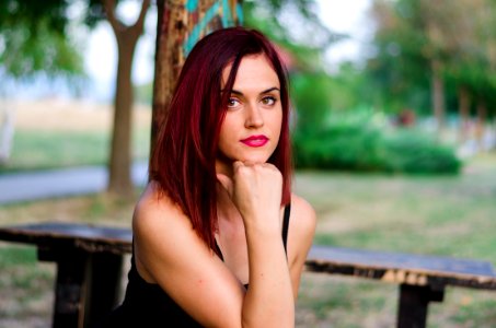 Woman In Black Tank Top Sitting On Bench photo