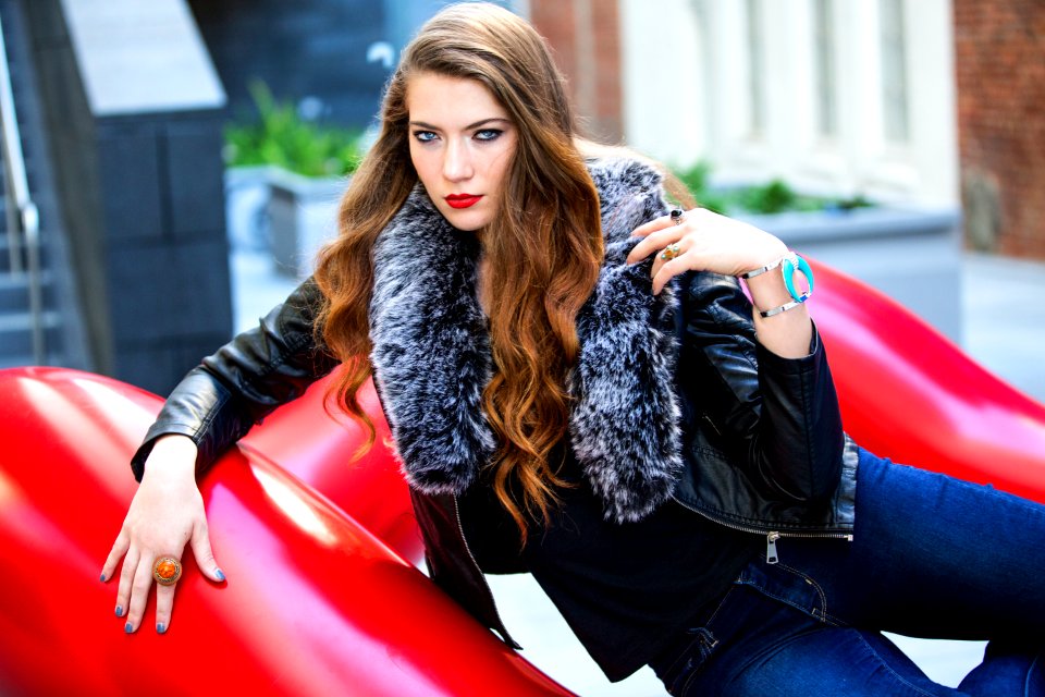Closeup Photo Of Woman Wearing Black Leather Fur-lined Jacket And Blue Denim Bottoms photo