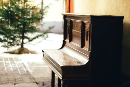 Brown Wooden Upright Piano In Shallow Focus Lens photo