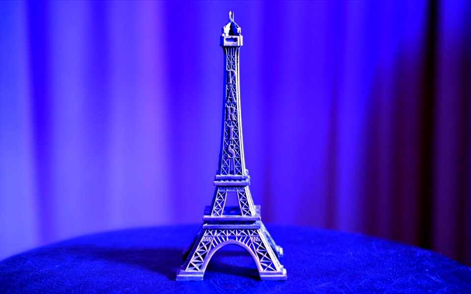 Eiffel Tower Miniature On Blue Textile