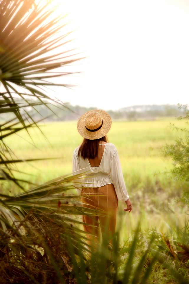 Woman In White Scoop-neck Long-sleeved Blouse With Brown Pants