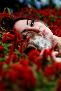 Photography Of A Woman Lying On Flowers photo