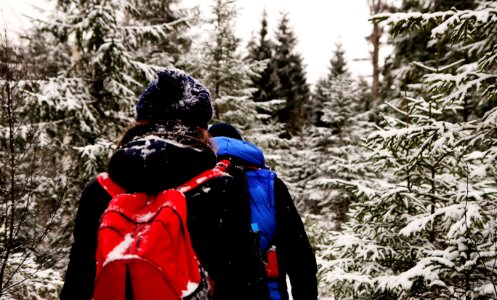 Two People Wearing Jacket And Red Backpack During Winter Season photo