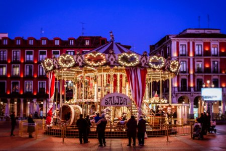 Group Of People Standing At The Front Of Carousel