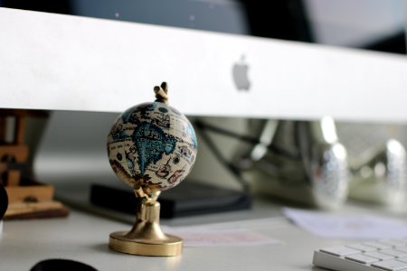 Globe On Top Of White Wooden Table photo