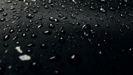Macro Photography Of Rain Drops On Black Surface photo