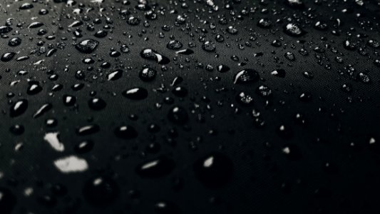 Macro Photography Of Rain Drops On Black Surface