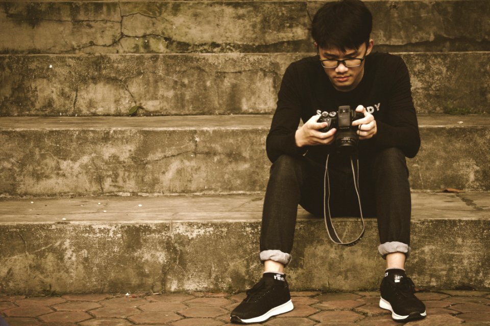 Photography Of A Woman Holding DSLR Camera
