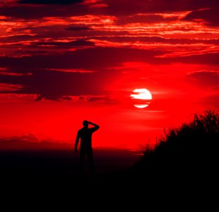 Silhouette Of Man During Red Sun photo