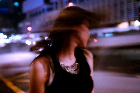Tilt Shift Photography Of Woman Wearing Tank Top During Nighttime photo