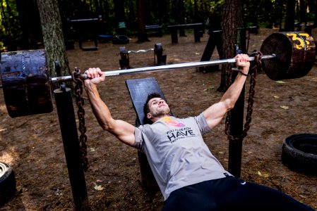 Man In Grey Shirt And Black Bottom Lifting Barbell