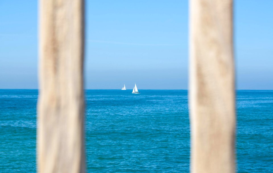 White Sailing Boat On Body Of Water