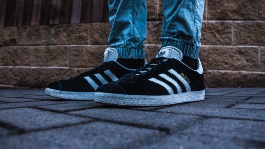Person Wearing Pair Of Black-and-white Adidas Gazelle photo