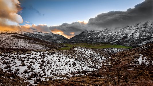 Scenic Photography Of Mountains Covered With Snow Under Cloudy Sky photo