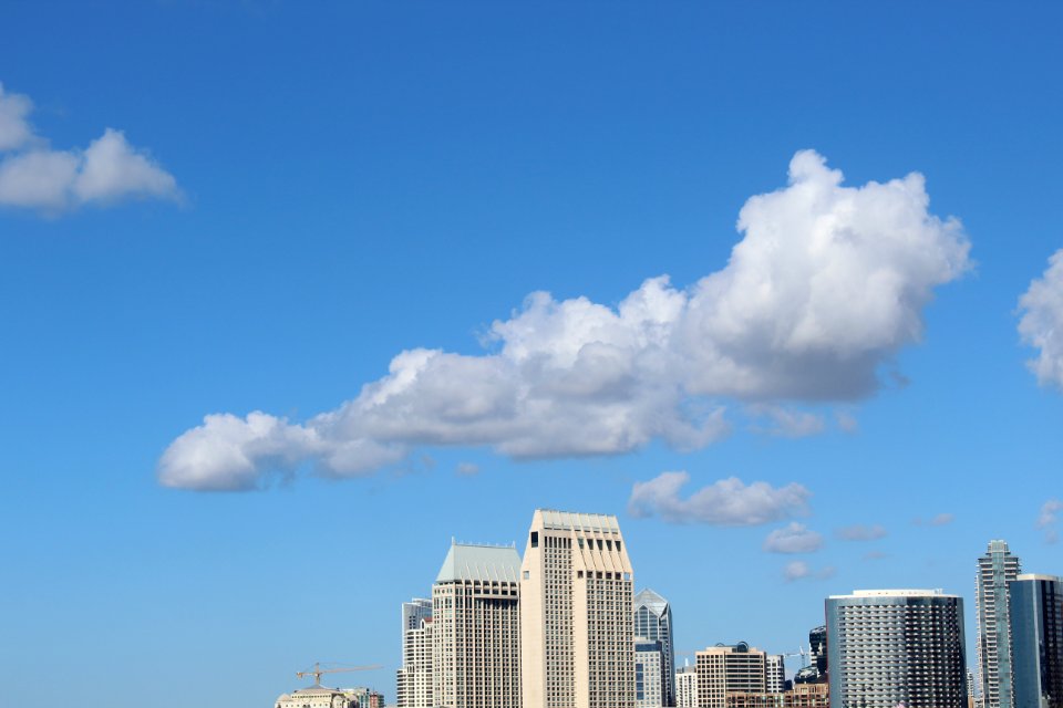 Cumulus Clouds Above High-rise Building photo