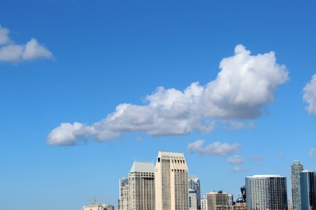 Cumulus Clouds Above High-rise Building photo