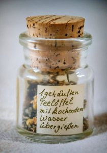 Paper Inside Clear Glass Jar With Brown Cork photo