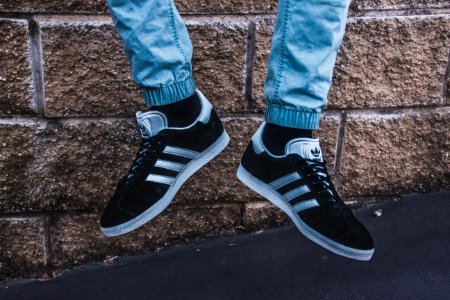 Photography Of A Person Wearing Adidas Gazelle photo
