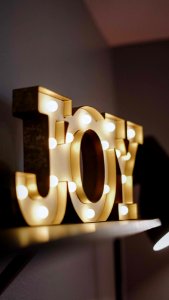 Selective Focus Photography Of Joy Free Standing Letters With Lights photo