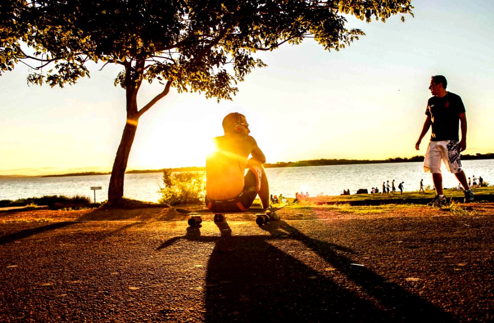 Photo Of Man Sitting On Skateboard