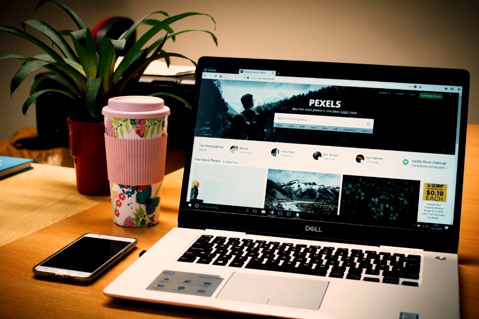 Photo Of A Gray Dell Laptop Displaying Pexels Webpage
