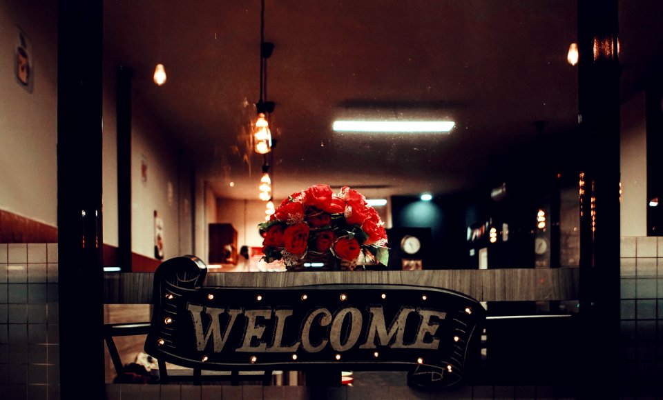 Black Welcome Signage Under Pendant Lamp Photography