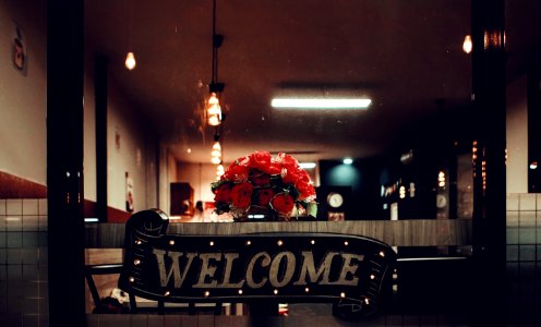 Black Welcome Signage Under Pendant Lamp Photography