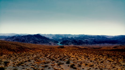 Brown Sand Near Mountain Under Cloudy Sky