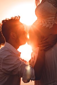 Man Kissing Womans Belly photo