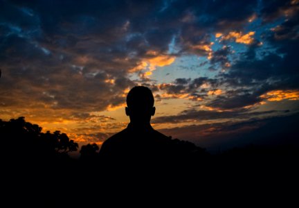 Silhouette Of Man Watching Golden Hour photo