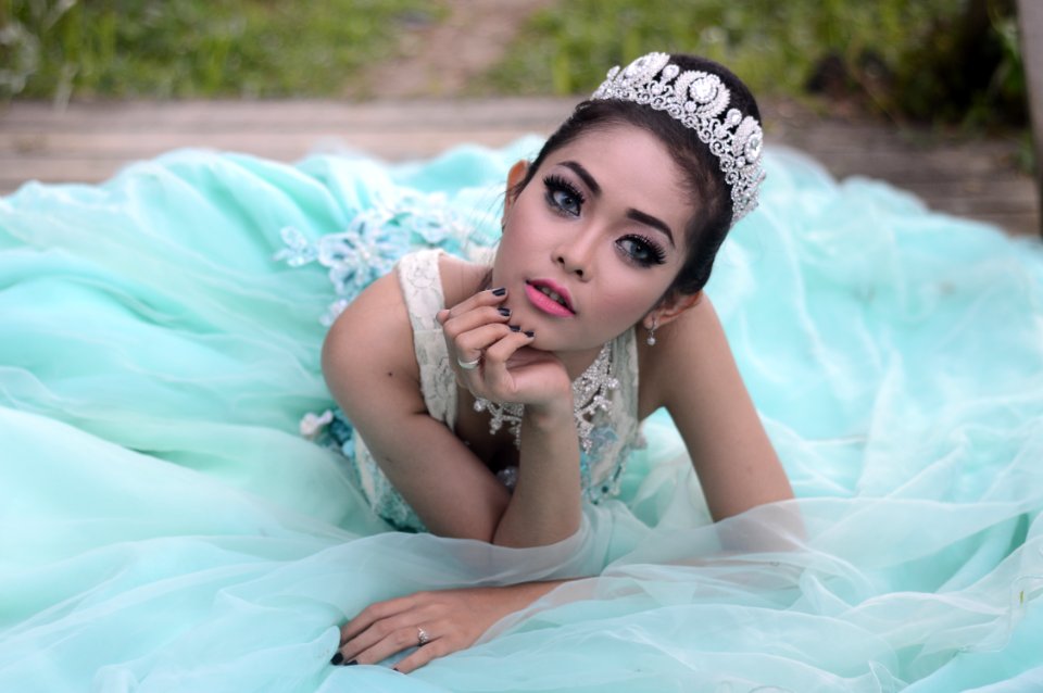 Woman Wearing Teal Dress In Reclining Position