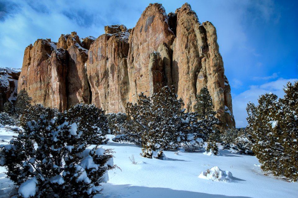 Landscape Photography Of Brown Mountain Near Snowy Trees Under Cloudy Blue Sky