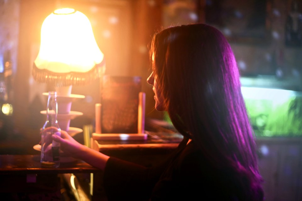 Photography Of A Woman Holding Beer Bottle