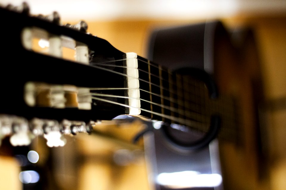 Selective Focus Photo Of Black Classical Guitar