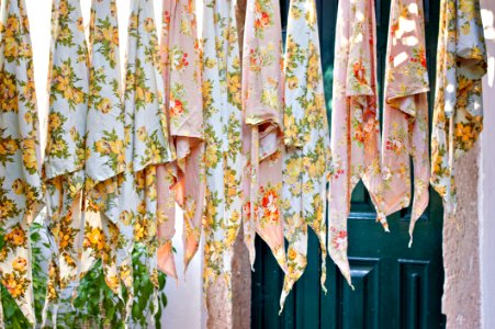 Assorted Textile Lot Hanging Beside Blue Wooden Door photo