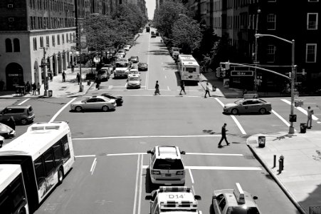 Greyscale Photo Of Car And People On Streets photo